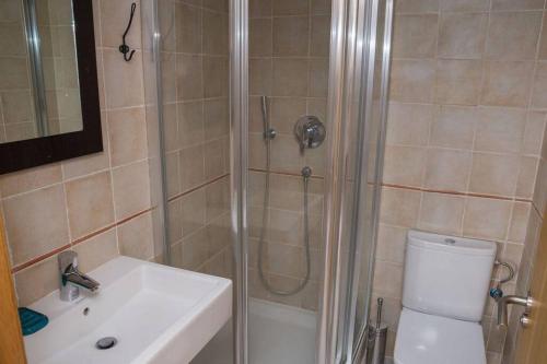 a bathroom with a shower and a toilet and a sink at Macenas Beach Resort Mojacar -Almeria in Mojácar