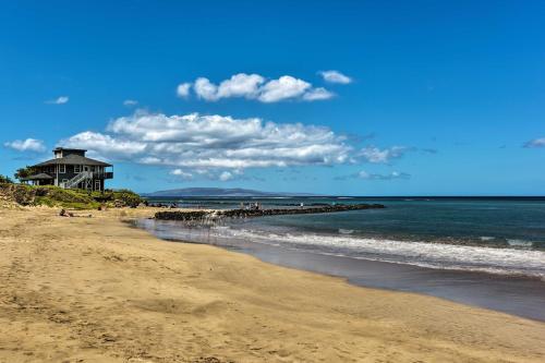 a beach with a house and the ocean at Stunning South Maui Condo with Lanai by Beach! in Kihei