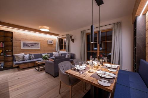 a living room with a table and a couch at Brunnenhof Luxury Apartments in Lech am Arlberg
