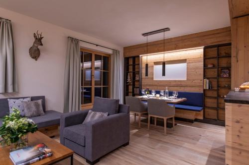 a living room with a couch and a table at Brunnenhof Luxury Apartments in Lech am Arlberg