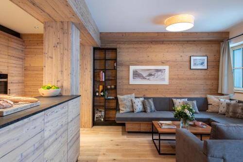 a living room with a couch and a table at Brunnenhof Luxury Apartments in Lech am Arlberg