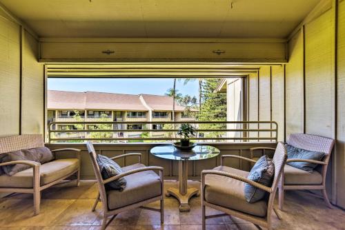 a balcony with chairs and a table and a window at Stunning South Maui Condo with Lanai by Beach! in Kihei