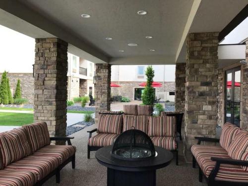 a patio with couches and a table and a fireplace at Berlin Grande Hotel in Berlin