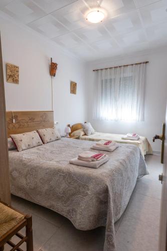 a bedroom with two beds with towels on them at Casa rural LAS TABLAS in Riópar