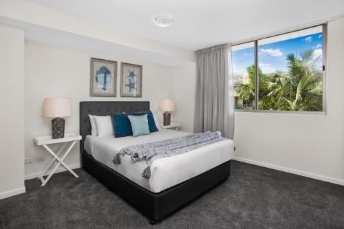 a bedroom with a large bed and a window at 2-Bed Near Brisbane CBD with Pool, Sauna & BBQ in Brisbane