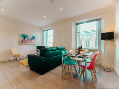 a living room with a green couch and a table at Spacesavers in Sheffield