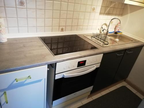 a kitchen with a sink and a stove at Haus Maria in Fischbach