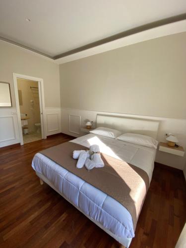 a bedroom with a bed with a stuffed animal on it at MAMO al Museo in Naples