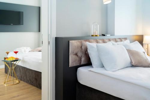 a bedroom with a bed and a table with a glass of wine at Niss Lara Hotel in Antalya