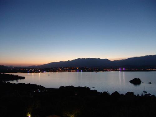 a view of a large body of water at night at Private Hôtel - Adults Only in Porto-Vecchio