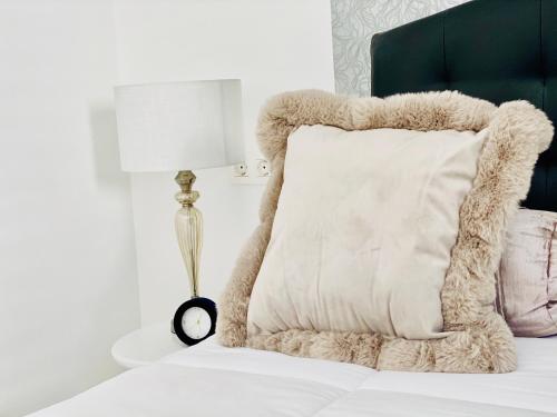 a bed with a white pillow and a lamp at Canaryislandshost l Brisa del Atlántico in Playa Honda