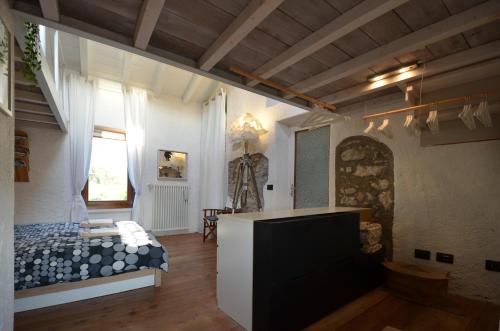 a bedroom with a bed and a tv in a room at Casa Gaino in Toscolano Maderno
