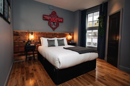 a bedroom with a bed with a baseball sign on the wall at BrewDog Kennels - Aberdeen in Aberdeen