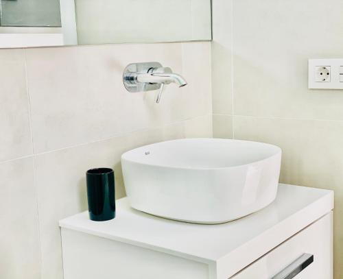 a bathroom with a white sink on a counter at Canaryislandshost l Brisa del Atlántico in Playa Honda