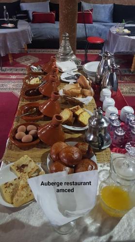 a table with many different types of pastries on it at Gite D'Etape Amced in Goulmima
