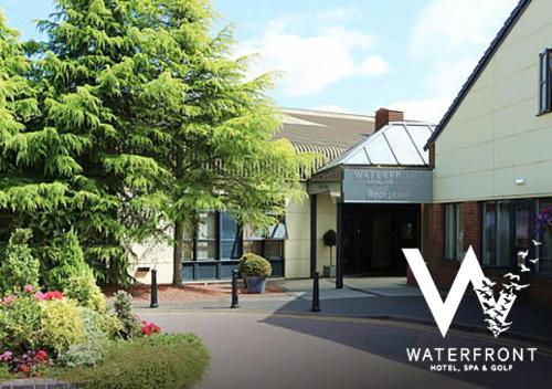 a building with a w sign in front of it at The Waterfront Hotel Spa & Golf in Saint Neots