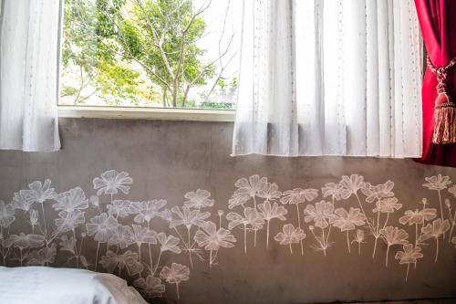 a bedroom with a flower mural on the wall at Farmland B&B in Guilin