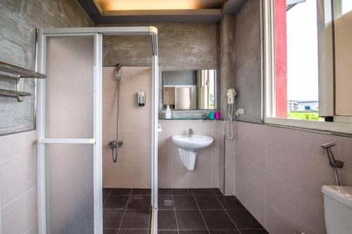 a bathroom with a shower and a sink at Farmland B&B in Guilin