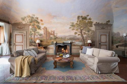 a living room with two couches and a fireplace at Villa de' Ricci Rignana B&B in Greve in Chianti