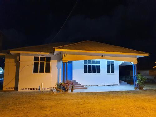 a small house in the desert at night at ALA Beach Lodge - Ketapang Homestay in Kota Bharu
