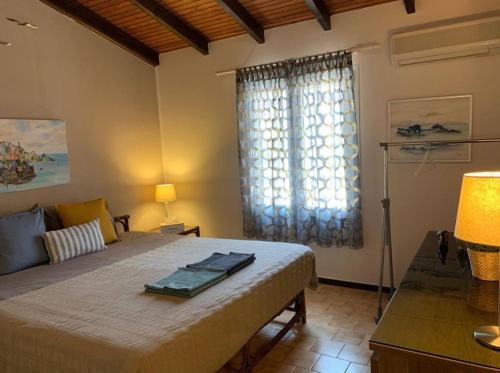 a bedroom with a large bed and a window at Casa Del Mare (South Evia) in Nea Stira