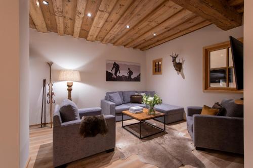 a living room with two couches and a table at Brunnenhof Luxury Apartments in Lech am Arlberg
