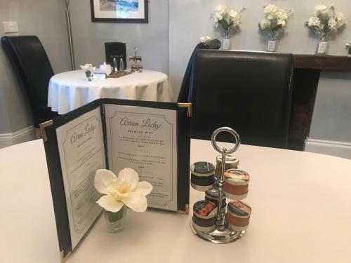 a table with a menu and two jars of food at Arran Lodge B&B in Torquay