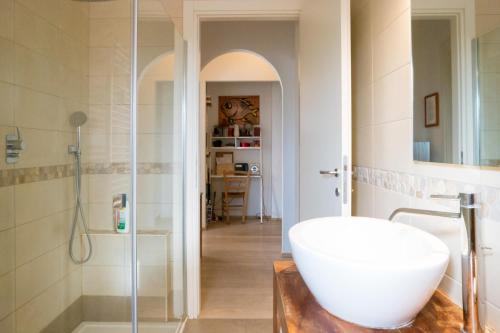 a bathroom with a white sink and a shower at Casa Musica Sol in Verona