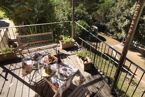 a table and a bench on a balcony at Alpaca country house in Pontedera