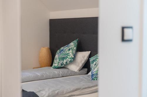 a living room with a couch with pillows on it at Apartamenty Pod Zamkiem w Janowcu in Janowiec