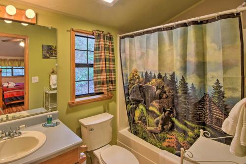 a bathroom with a shower curtain with monkeys on it at Modern Cabin with Deck in the Blue Ridge Mountains! in Blairsville
