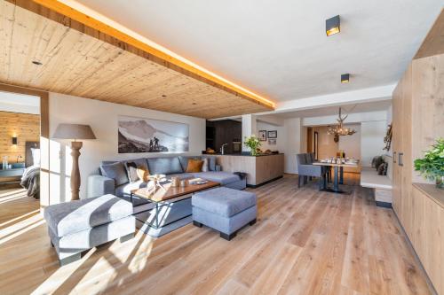 a living room with a couch and a table at Brunnenhof Luxury Apartments in Lech am Arlberg