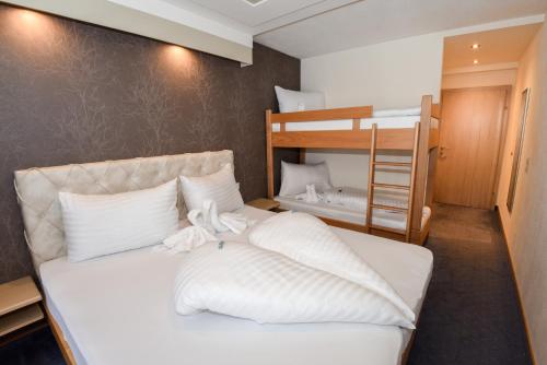 a bedroom with a bed and a bunk bed at Golf & Skipension Krug in Haus im Ennstal
