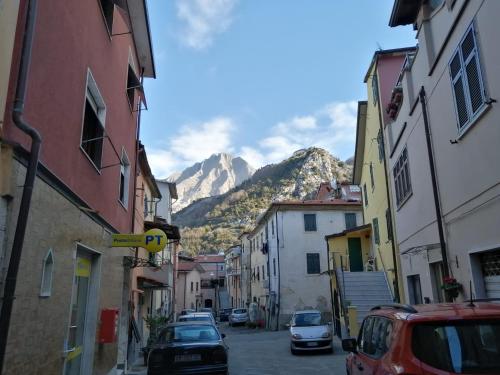 a street with cars parked on a street with a mountain at A CA' DI GIO' in Bedizzano