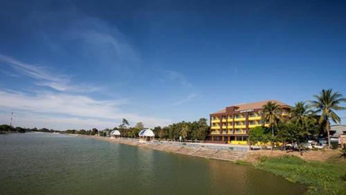 a hotel on the shore of a body of water at Amatara Hotel in Pi Mai