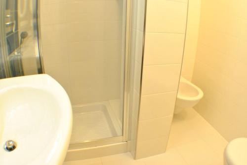 a bathroom with a shower and a sink and a toilet at Hotel Bristol in Laigueglia