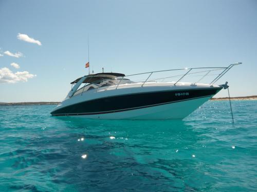 a boat sitting in the water in the ocean at Hotel Rural & Spa Can Curreu in Sant Carles de Peralta