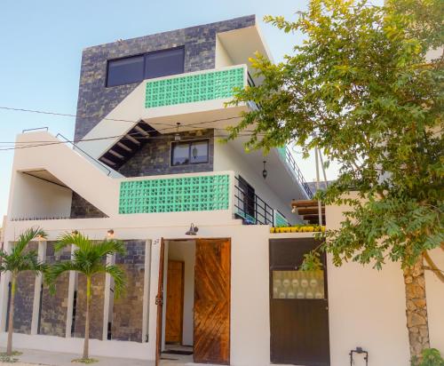 a modern house with white and green accents at Les Suites Calle 2 by Galian in Tulum