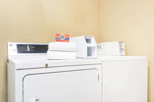 a room with a white refrigerator with items on it at Super 8 by Wyndham Wausau in Wausau