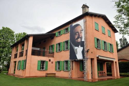 a building with a picture of a man on the side of it at La casa del Centro in Modena