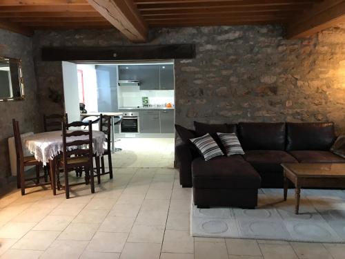 ein Wohnzimmer mit einem Sofa und einem Tisch in der Unterkunft Morvan La Pastourelle in Quarré-les-Tombes