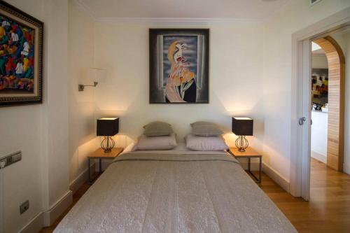 a bedroom with a large bed with two lamps at Sabater in Altea