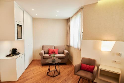 a living room with a couch and two chairs at Ramada Plaza by Wyndham Thraki in Alexandroupoli