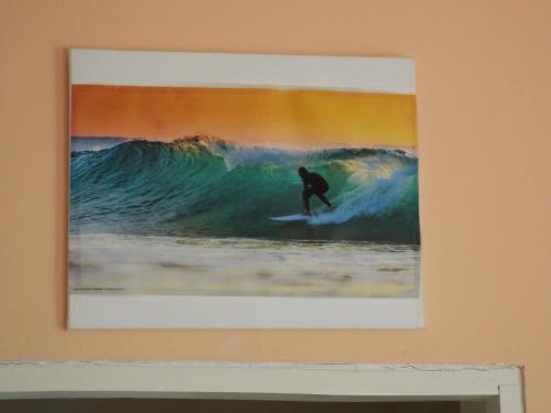 a picture of a man riding a wave on a surfboard at LAKE VIEW CONDO in Belize City