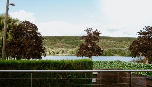 a view of a lake from a fence at Les Terrasses sur Seine in Vernon