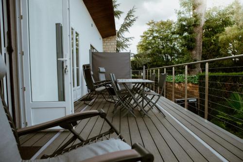 a patio with chairs and a table on a deck at Les Terrasses sur Seine in Vernon