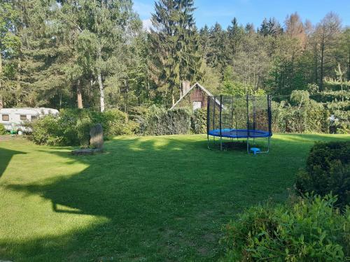a large yard with a trampoline in the grass at Pension Kachlicka in Skála