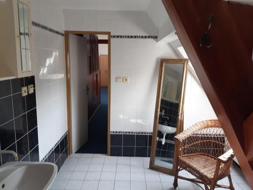 a bathroom with a sink and a mirror at Pension Kachlicka in Skála