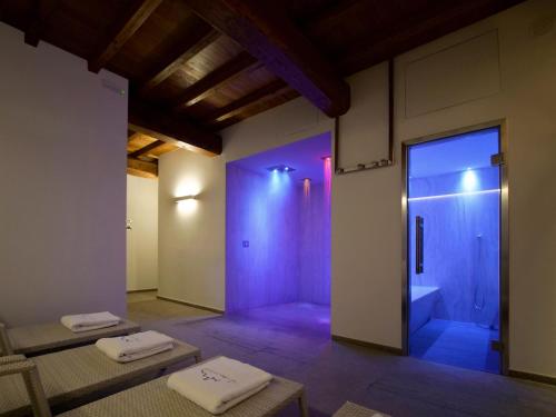 a bathroom with a shower and two towels on the floor at Fattoria Lucciano in Borghetto