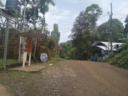a dirt road with a sign on the side of the road at Hotel El Congo in Drake